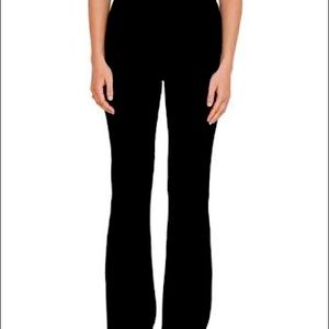 Black stretchy material slim fit then kinda flare at the bottom